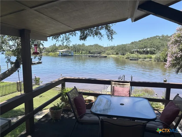 a view of a chairs and table on the deck