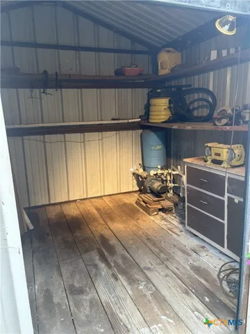 a room with wooden furniture and a window
