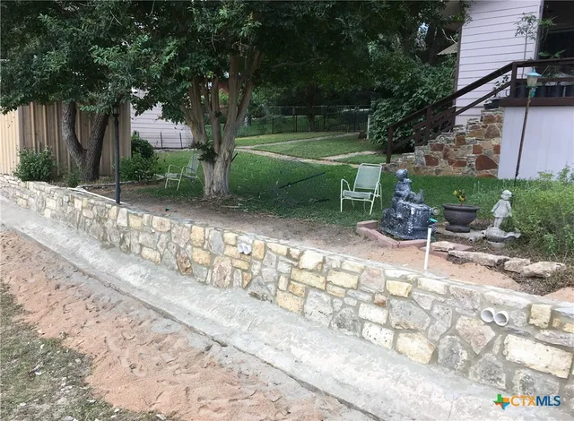 a view of a chairs and table in the backyard