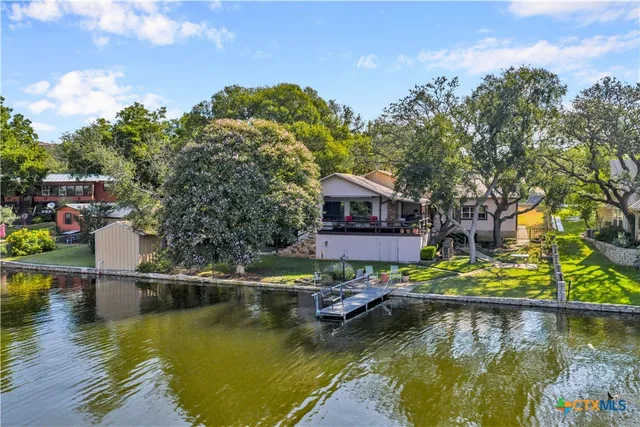 a view of house with swimming pool yard and outdoor seating