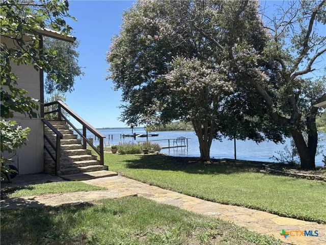 a view of a yard with wooden fence