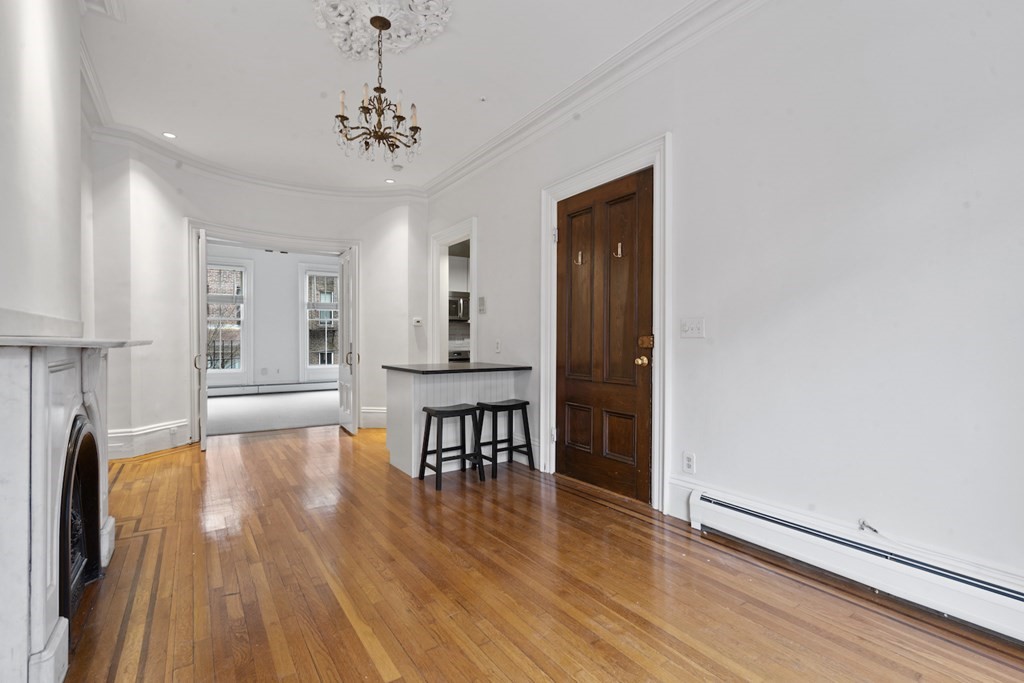 103 Appleton Street, Unit 3 Boston, MA 02116 - Photo 5 of 11 a view of a room with wooden floor lounge chair and windows