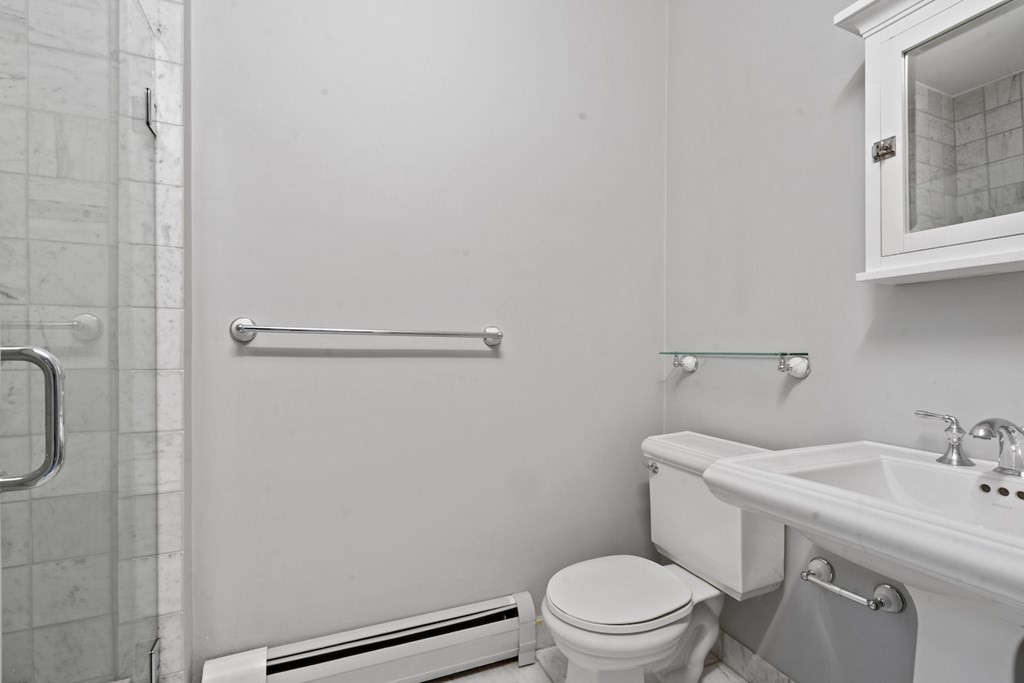 103 Appleton Street, Unit 3 Boston, MA 02116 - Photo 8 of 11 a bathroom with a sink a toilet and a mirror