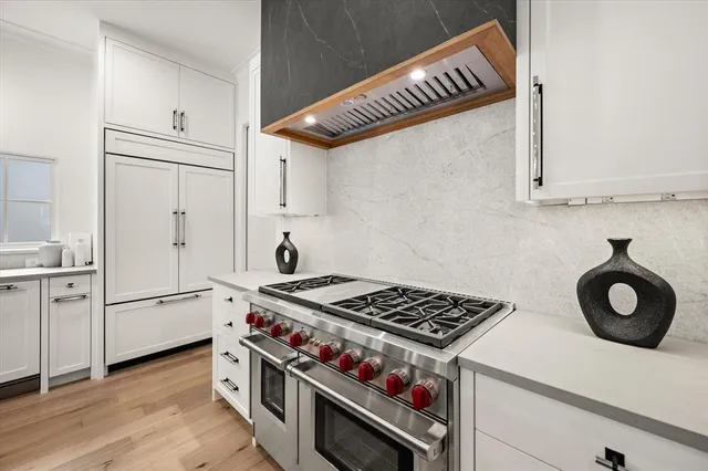 a kitchen with white cabinets and white appliances