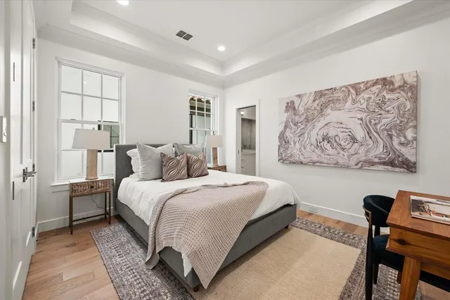 a bedroom with a bed and a painting on the wall