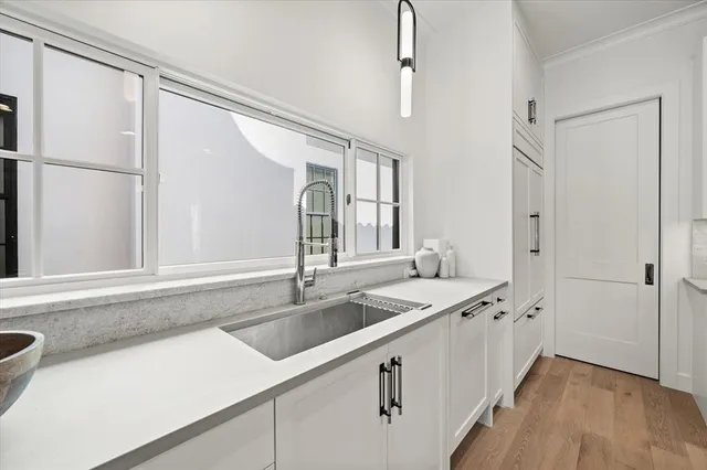 a kitchen with stainless steel appliances granite countertop a sink and a refrigerator