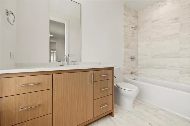 a bathroom with a sink a toilet and bathtub