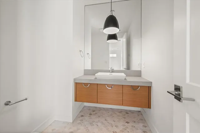 a view of bathroom with a sink and mirror