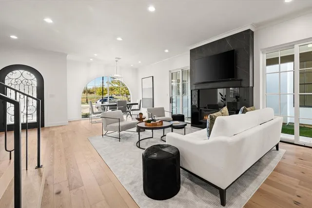a living room with fireplace furniture and a flat screen tv