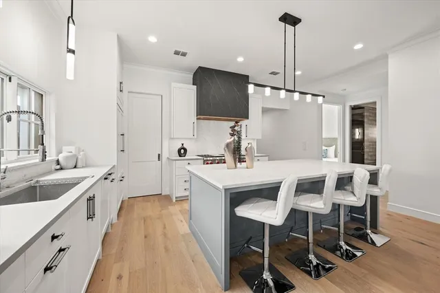 a large kitchen with a table and chairs
