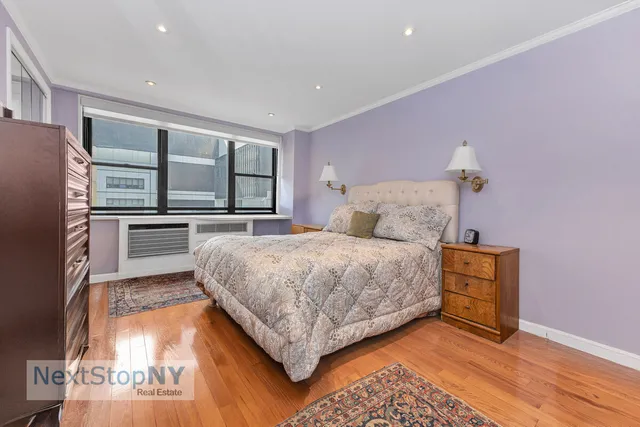 a bedroom with a large bed and a dresser