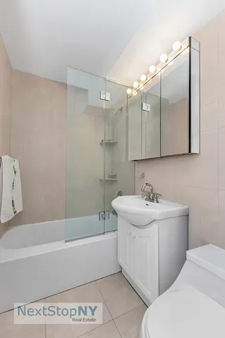 a bathroom with a sink a toilet and bathtub