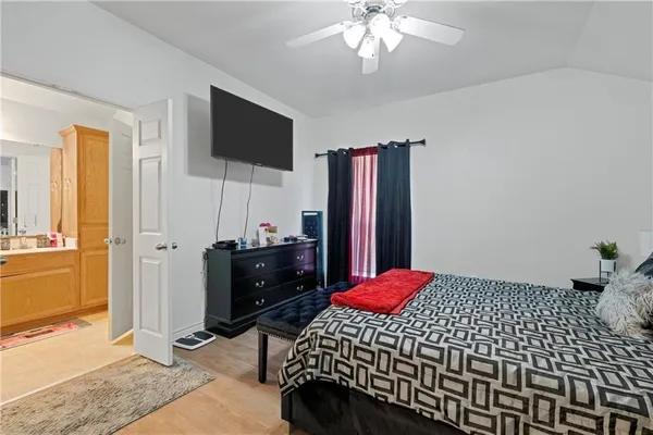 a bedroom with a bed and a flat screen tv