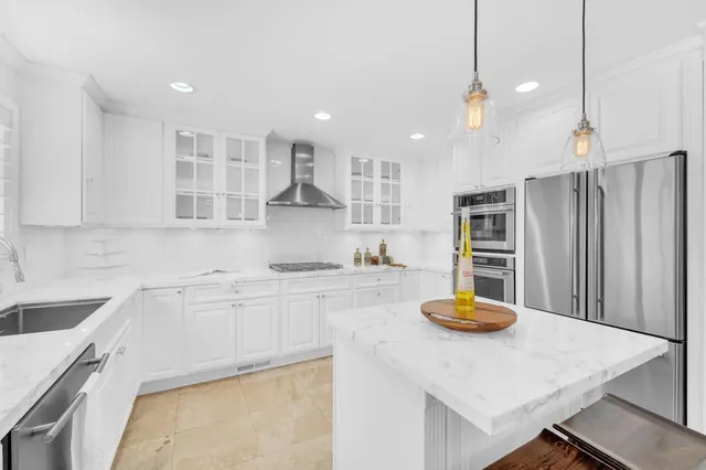 a kitchen with stainless steel appliances granite countertop a sink and cabinets