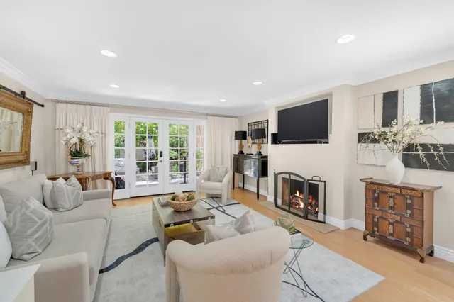 a living room with fireplace furniture and a flat screen tv