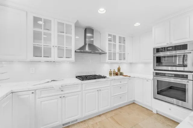 a kitchen with stainless steel appliances a refrigerator sink and cabinets