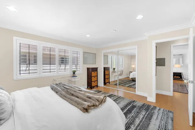 a bed room with a bed and a large window