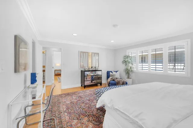 a bathroom with a tub a sink and a large mirror