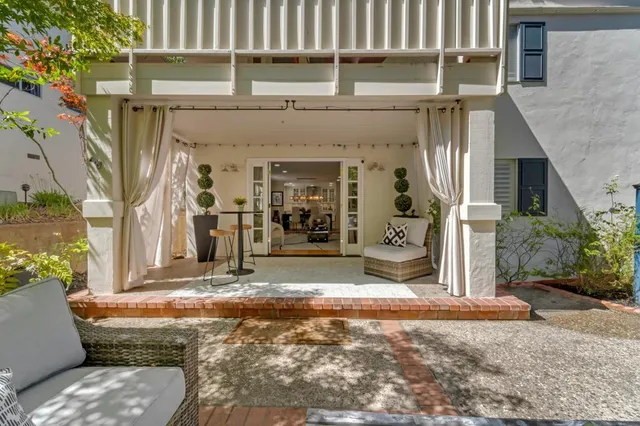 a view of patio with couches and a fire pit