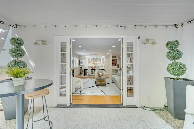 a living room with furniture and a potted plant