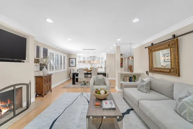 a living room with fireplace furniture and a wooden floor
