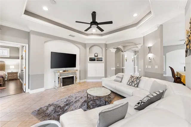 a living room with furniture a flat screen tv and a fireplace