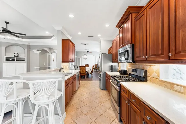 a kitchen with stainless steel appliances granite countertop a stove a sink dishwasher and a refrigerator