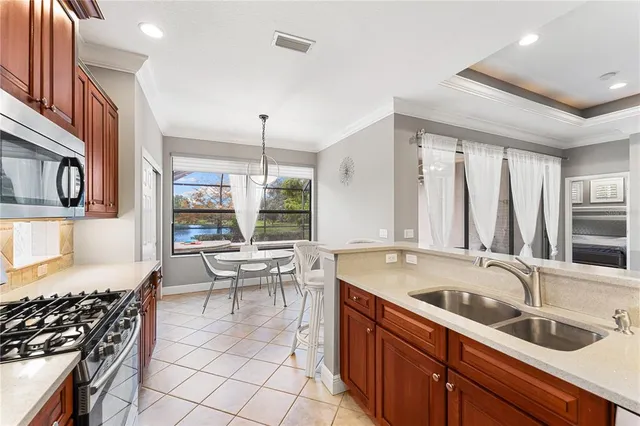 a kitchen with a sink and a stove top oven