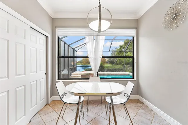 a dining room with chandelier and outdoor view