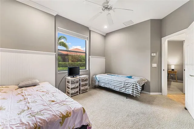 a bedroom with a bed and large window