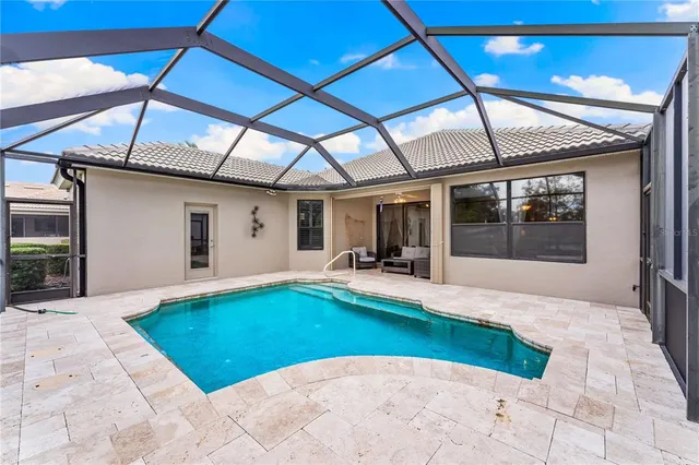 a view of a patio with a table and chairs under an umbrella