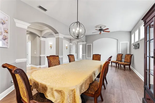 a view of a dining room with furniture and chandelier