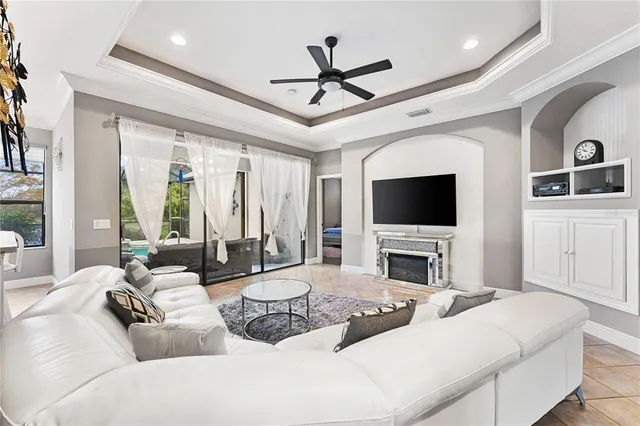 a living room with furniture a flat screen tv and a large window