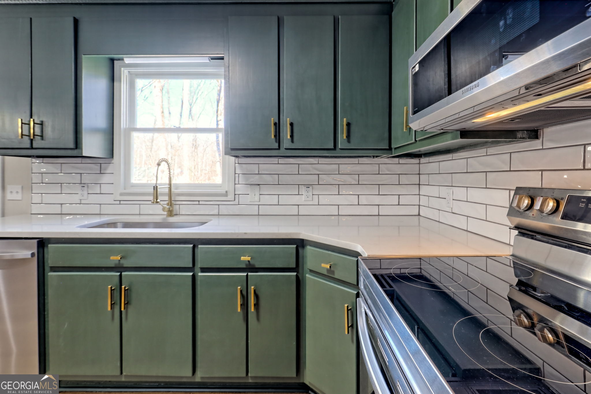 233 Piney Ridge Road Jasper, GA 30143 - Photo 10 of 38 a kitchen with a sink and a stove