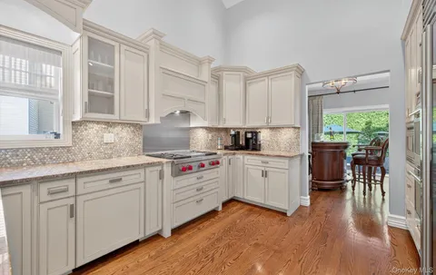 a kitchen with granite countertop white cabinets and white appliances