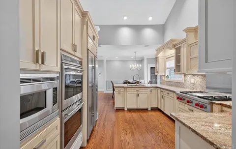 a kitchen with stainless steel appliances granite countertop a stove and a sink