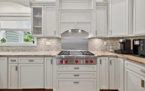 a stove top oven sitting inside of a kitchen