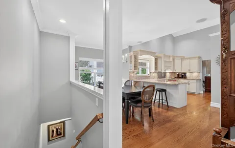 a kitchen with a table chairs refrigerator and cabinets