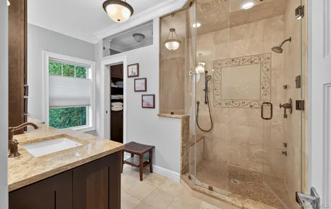 a bathroom with a granite countertop sink a shower and a mirror
