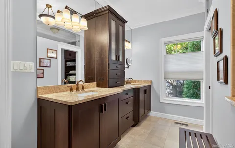 a spacious bathroom with a double vanity sink and a mirror