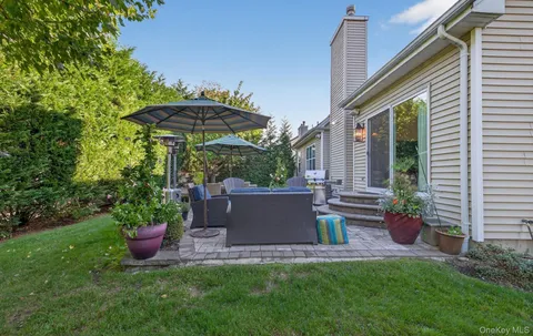 a view of a chair and table under an umbrella