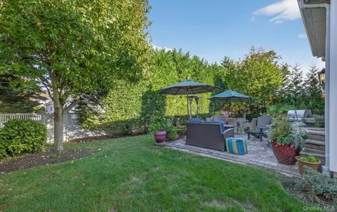 a backyard of a house with table and chairs