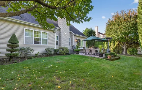 a front view of a house with a yard table and chairs