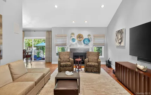 a living room with fireplace furniture and a flat screen tv