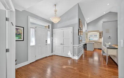 a view of a living room kitchen and a wooden floor