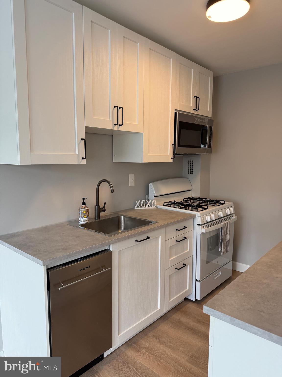 a kitchen with stainless steel appliances granite countertop a sink and a stove top oven