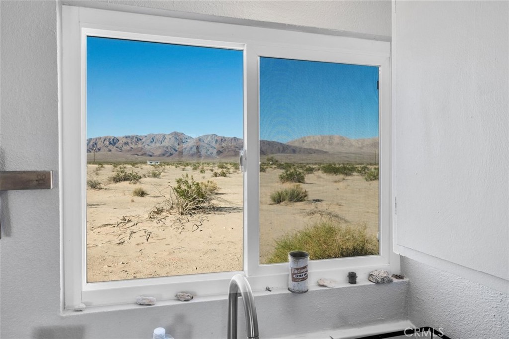 84753 Eddie Albert Road Twentynine Palms, CA 92277 - Photo 12 of 52 a view of a window and a table in a living room