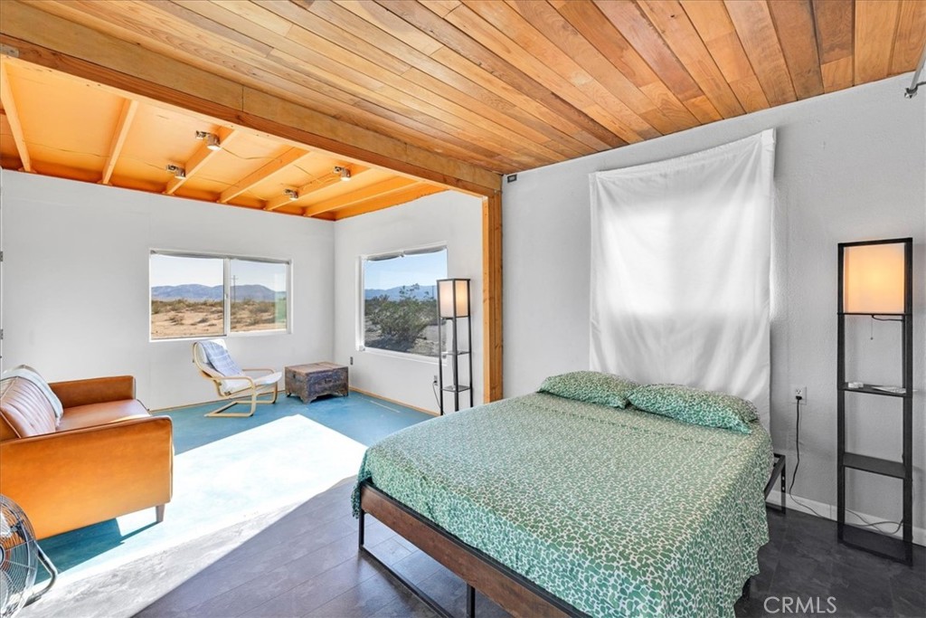 84753 Eddie Albert Road Twentynine Palms, CA 92277 - Photo 15 of 52 a bedroom with a large bed and a couch