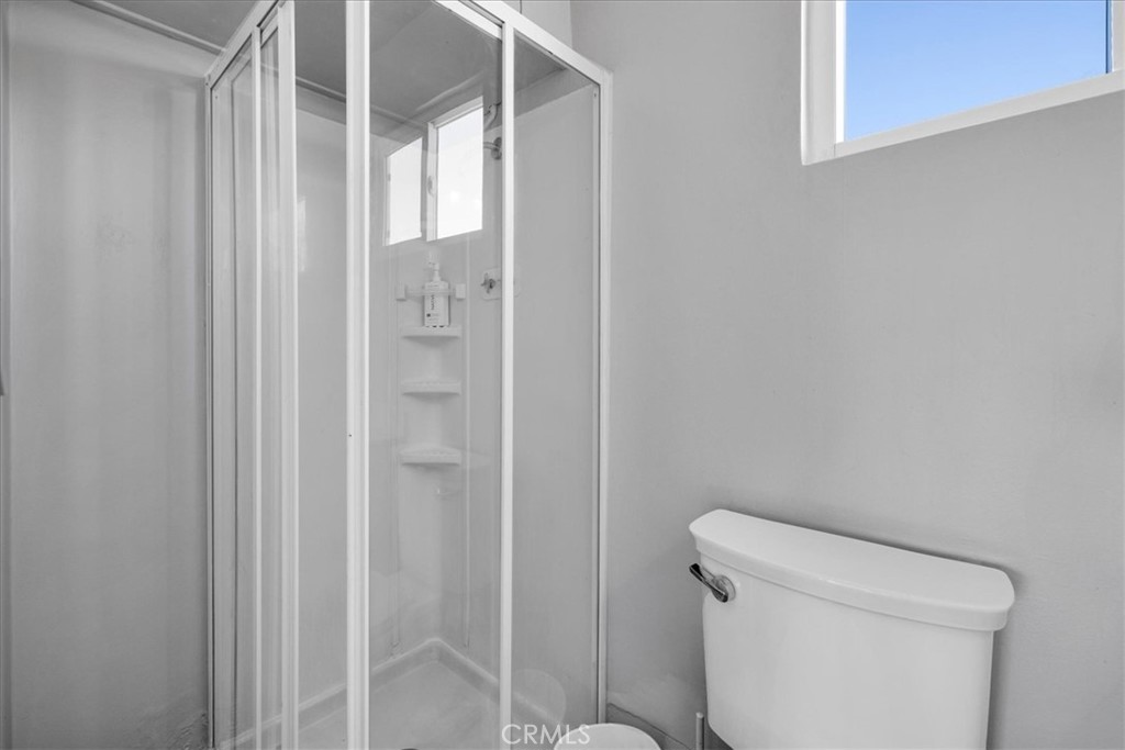 84753 Eddie Albert Road Twentynine Palms, CA 92277 - Photo 22 of 52 a bathroom with a shower and a toilet