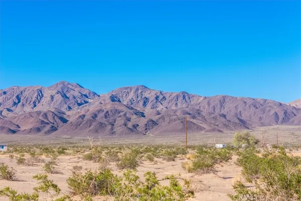 a view of an ocean beach and mountain